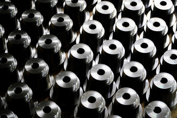 Shiny steel parts background. Regular industrial metal production pattern with selective focus.High precision steel automotive parts manufacturing by innovative CNC machining