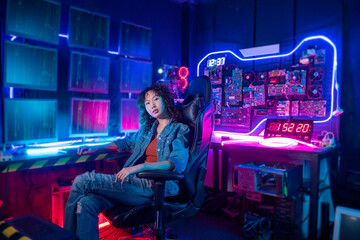 an asian woman programmer is working in her computer room , futuristic technology concept