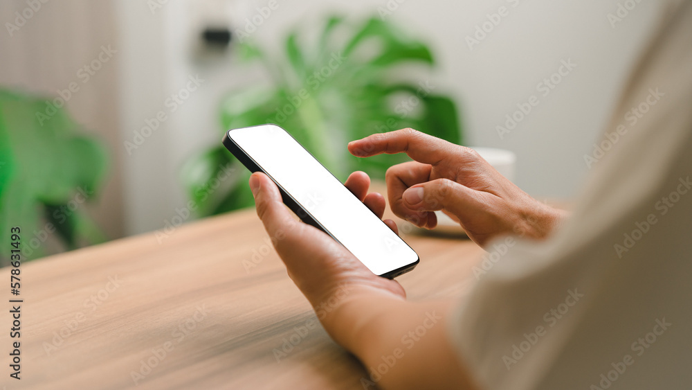 Poster Mockup mobile phone. Adult man holding and using smartphone with blank desktop screen while working and drinking coffee in cafe.