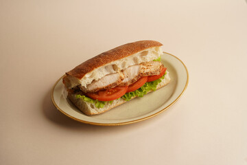 Sandwich with chicken breast, lettuce and tomato