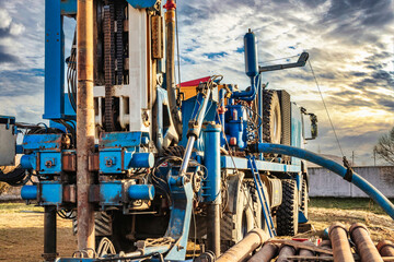 The drilling rig close-up is drilling a well against the background of the cloudy sky. Deep hole...