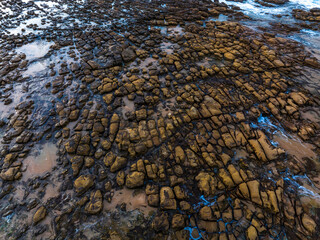 Top down view over tessellated rock platform at the seaside