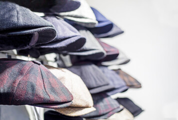 Traditional men's wool tweed caps are for sale. Horizontal