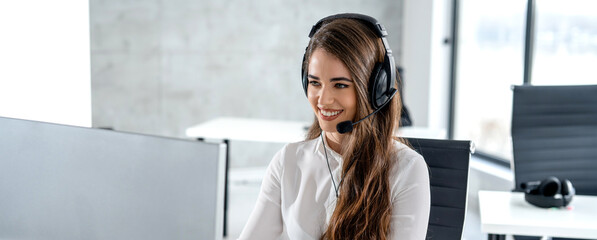 Panoramic shot, portrait of beautiful friendly woman wearing headset with microphone talking with...