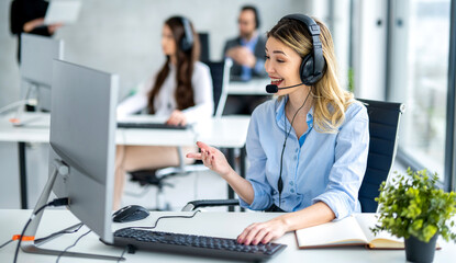 Dedicated female helpdesk service agent talking with client at call center.