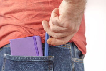 man carrying a notebook and pen in his pocket