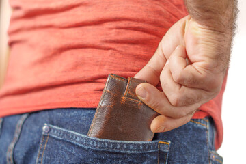 man putting his wallet in his trouser pocket