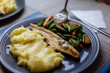 Potatoes with fish sauce and vegetables