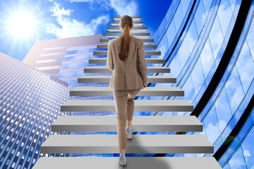 Steps to success. Businesswoman climbing up stairs among buildings