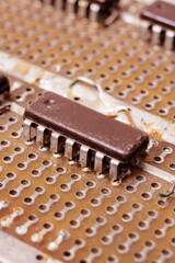 Old dirty yellow circuit board with transistors