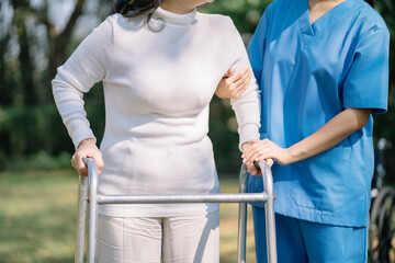 Professional physiotherapist taking care of asian senior patient during rehabilitation.