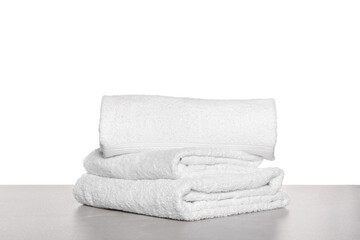 Fototapeta na wymiar Soft terry towels on light table against white background