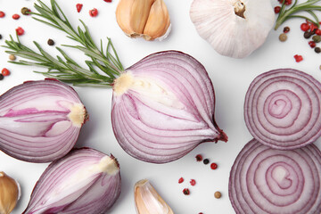 Fresh red onions, garlic, rosemary and spices on white background, flat lay