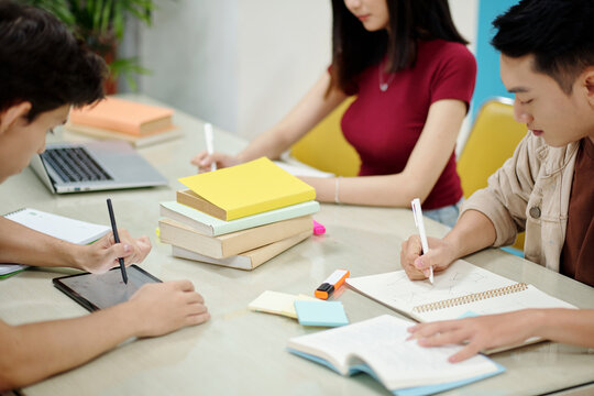 Group Of Students Doing Homework In School Library