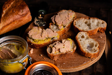 French baguette with foie gras on a wooden surface. Cooking bruschetta with goose liver. © Konstiantyn Zap