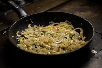 Roasting onions. Chopped onions are fried in a pan. Cooking food.
