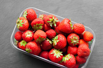 strawberry red fresh sweet in a tray ecologically clean farm berry vitamins proper nutrition diet health on a black background