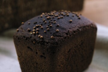 freshly baked bread with cumin. bread on the tablecloth. Home baked whole grain bread. Crusty sourdough loaf of wheat bread with wholegrain flour.