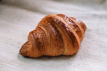 freshly baked croissant on a tablecloth	