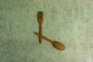 Diet food concept and fat loss. wooden fork and spoon. concept of intermitten fasting.