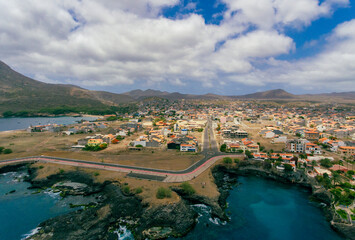 Fototapeta na wymiar Aerial photos of Tarrafal in Santiago Island, Cabo Verde showcase the stunning beaches and clear waters of this idyllic coastal town, as well as its colorful buildings, charming streets