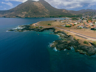 Aerial photos of Tarrafal in Santiago Island, Cabo Verde showcase the stunning beaches and clear waters of this idyllic coastal town, as well as its colorful buildings, charming streets