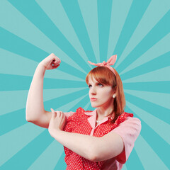 Confident housewife showing biceps and fist: women empowerment concept