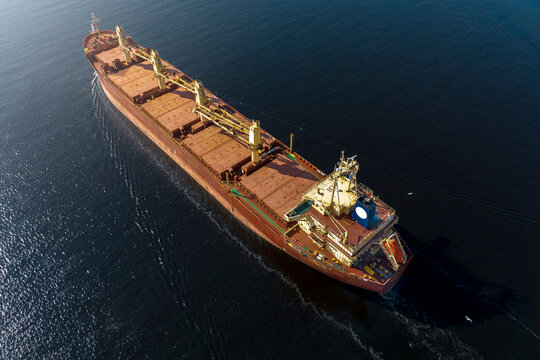 Large empty cargo ship in the sea during sunny summer day