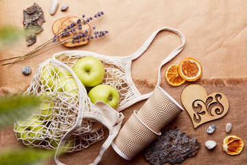 Natural, eco-friendly, plastic free, zero waste background. Eco shopping bag with apples, dry...