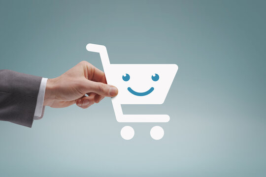 Customer Holding A Smiling Shopping Cart Icon