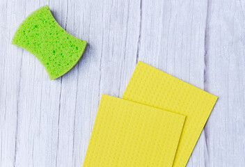 Dishwashing sponge and kitchen wipes on white background, top view. Sponges for dishes. Cleaning...