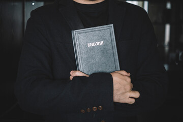 Holy Bible in men's hands. The concept of faith and religion. christian faith. The inscription on...