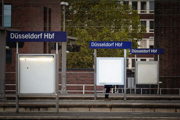 Selective blur on a sign indicating Dusseldorf Hbf, or Dusseldorf Hauptbahnhof, meaning in German...