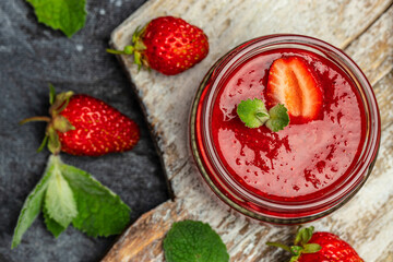 strawberry jam in a jar and fresh berries on the wooden board. banner, menu, recipe place for text