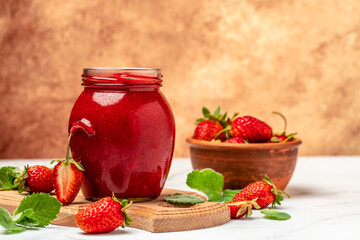 strawberry jam in a jar and fresh berries on white table. banner, menu, recipe place for text