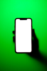 Phone in hand in neon green fog