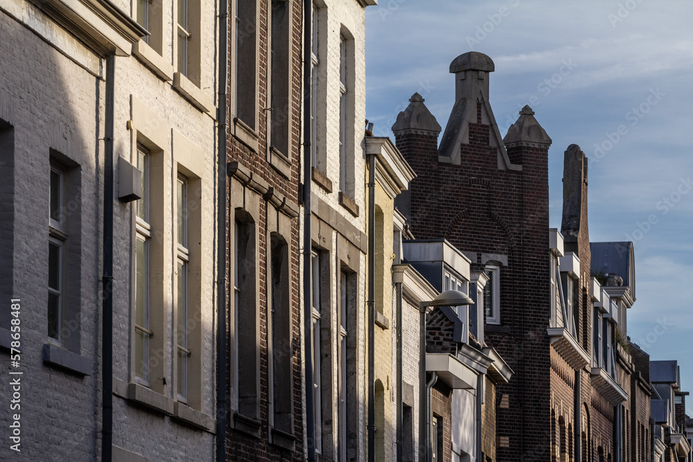 Wall mural old residential houses in the city center of maastricht, netherlands, in an old medieval street with