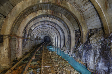 Fototapeta na wymiar Dark empty tunnel of old coal mine.