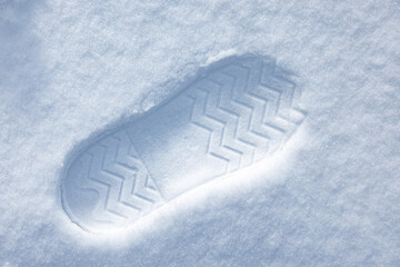 Boot imprint in a snowdrift on a sunny summer day, close-up