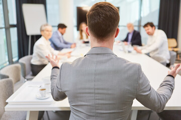 Businessman in the meeting gives an instruction