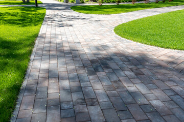Paving with paving slabs. Landscape architecture of a park. Decorative garden winding pathway...