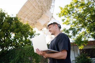 Engineer looking earth based astronomical radio telescope