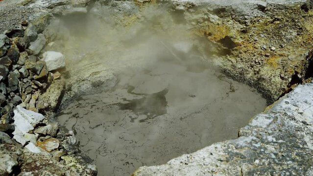 Pool Pits of volcanic origin contain boiling hot mud. Close-up footage.