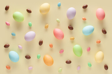 Happy Easter. Colorful Easter eggs and sweets on the yellow background. Pattern. flat lay.