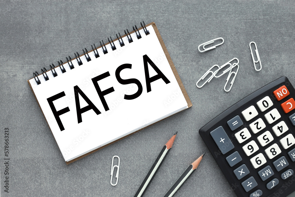 Poster Free Application for Federal Student Aid .FAFSA. concept.notepad with spring and text on white paper.