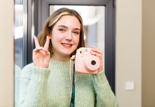 pretty young woman with a vintage photo camera. house interior design