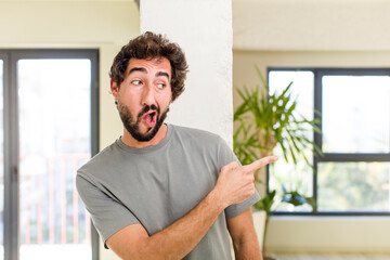 young adult crazy man with expressive pose at a modern house interior