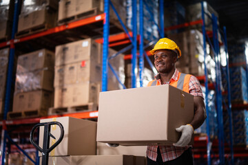 African American male warehouse worker hold cardboard box packaging in warehouse distribution center environment.