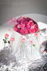 Beautiful bouquet of pink and red roses on a shiny background