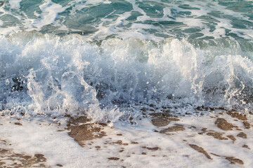 Sea wave rolling on the beach sand